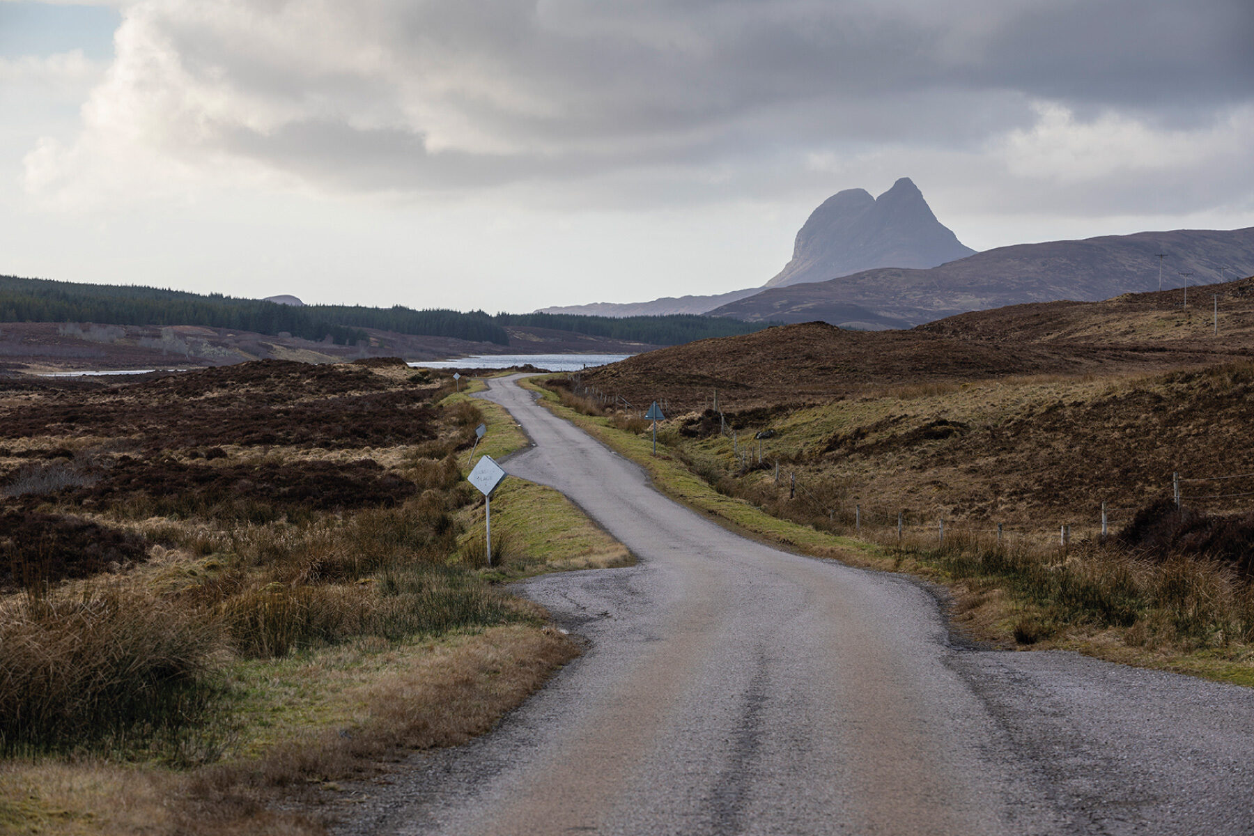 Sutherland landscape with road, passing place and Suilven mountain in the distance.