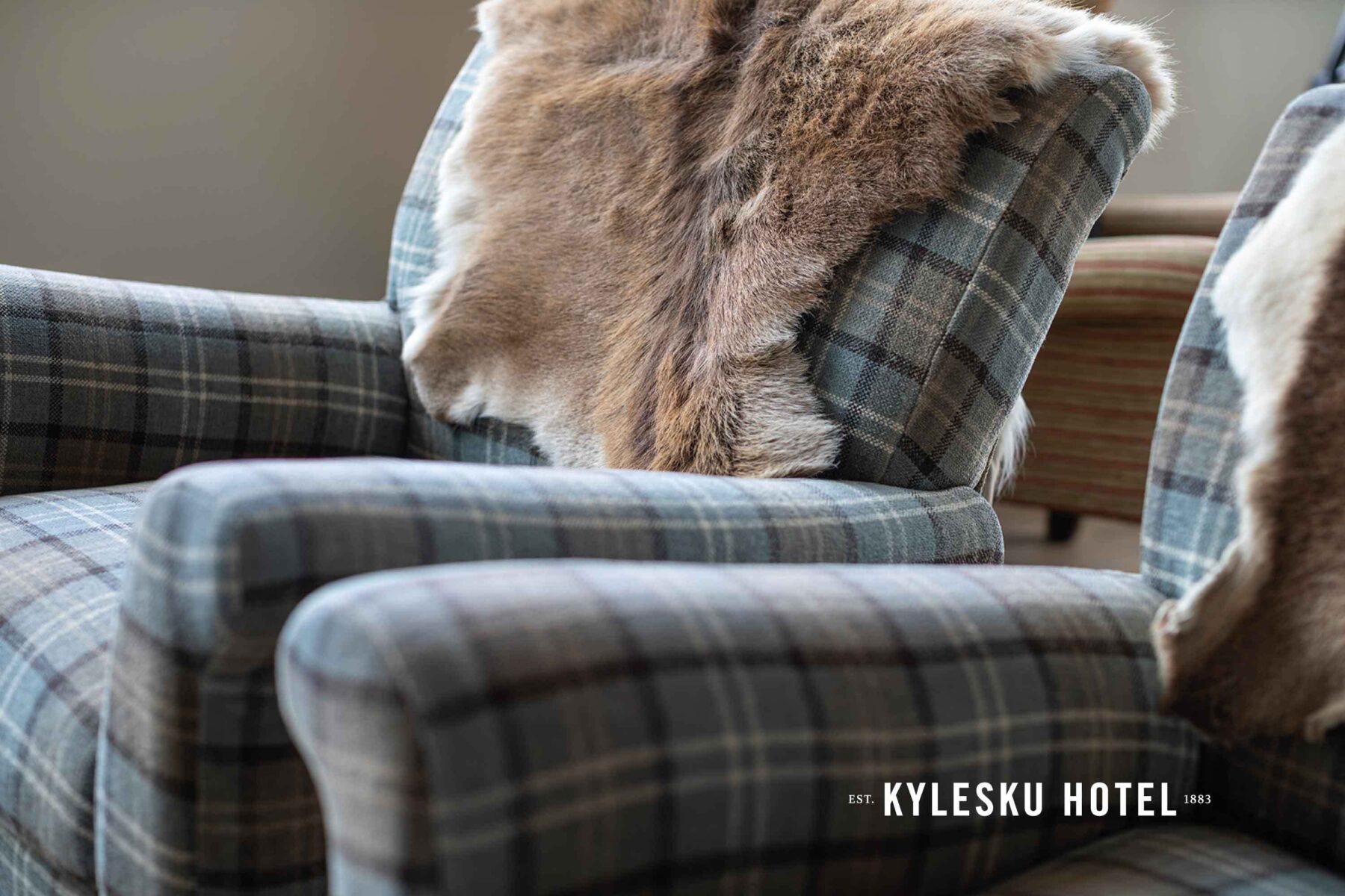 Tweed covered armchairs with deer skins. Kylesku Hotel, Scotland.