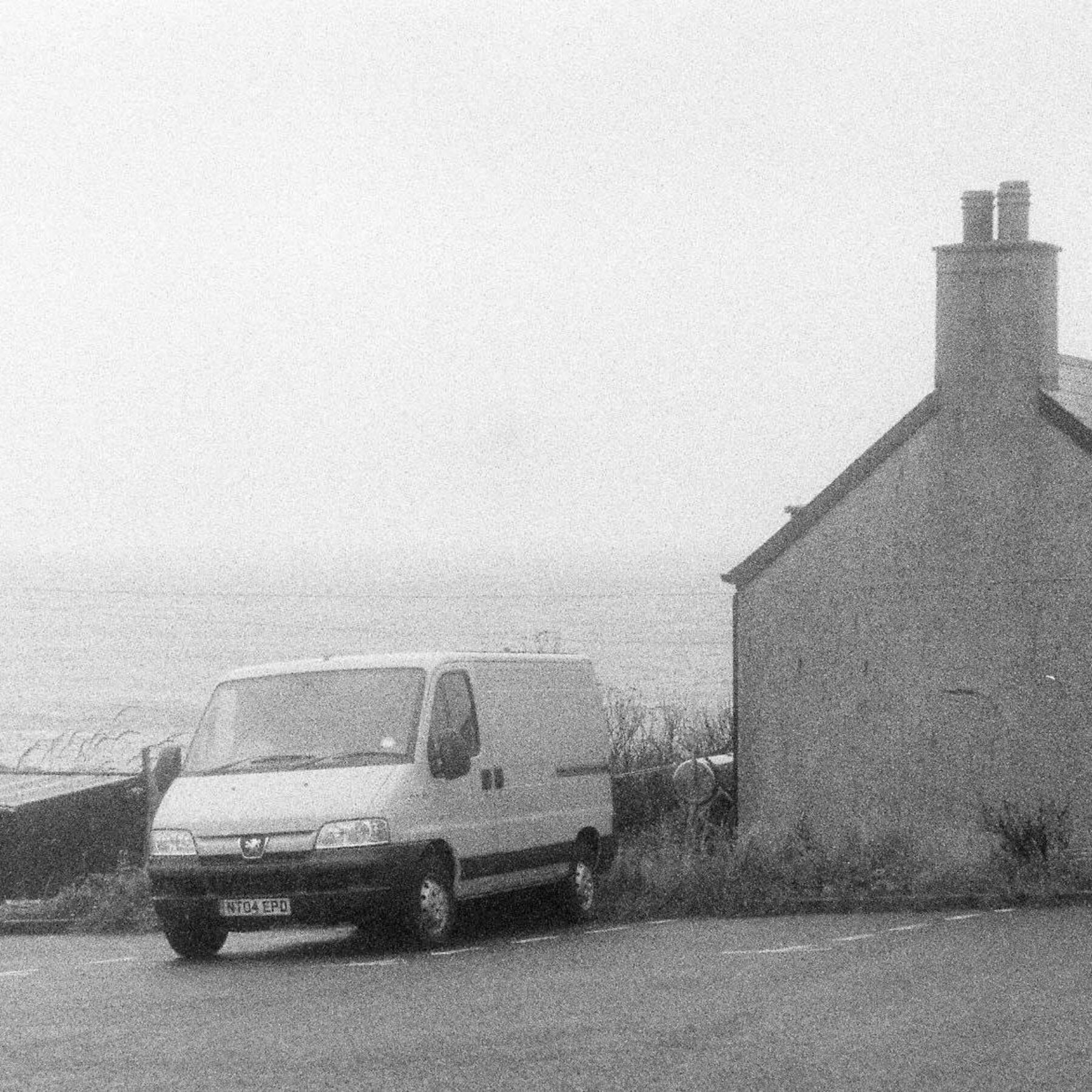 Black and white photo of cold morning in Hoswick car park, Shetland.