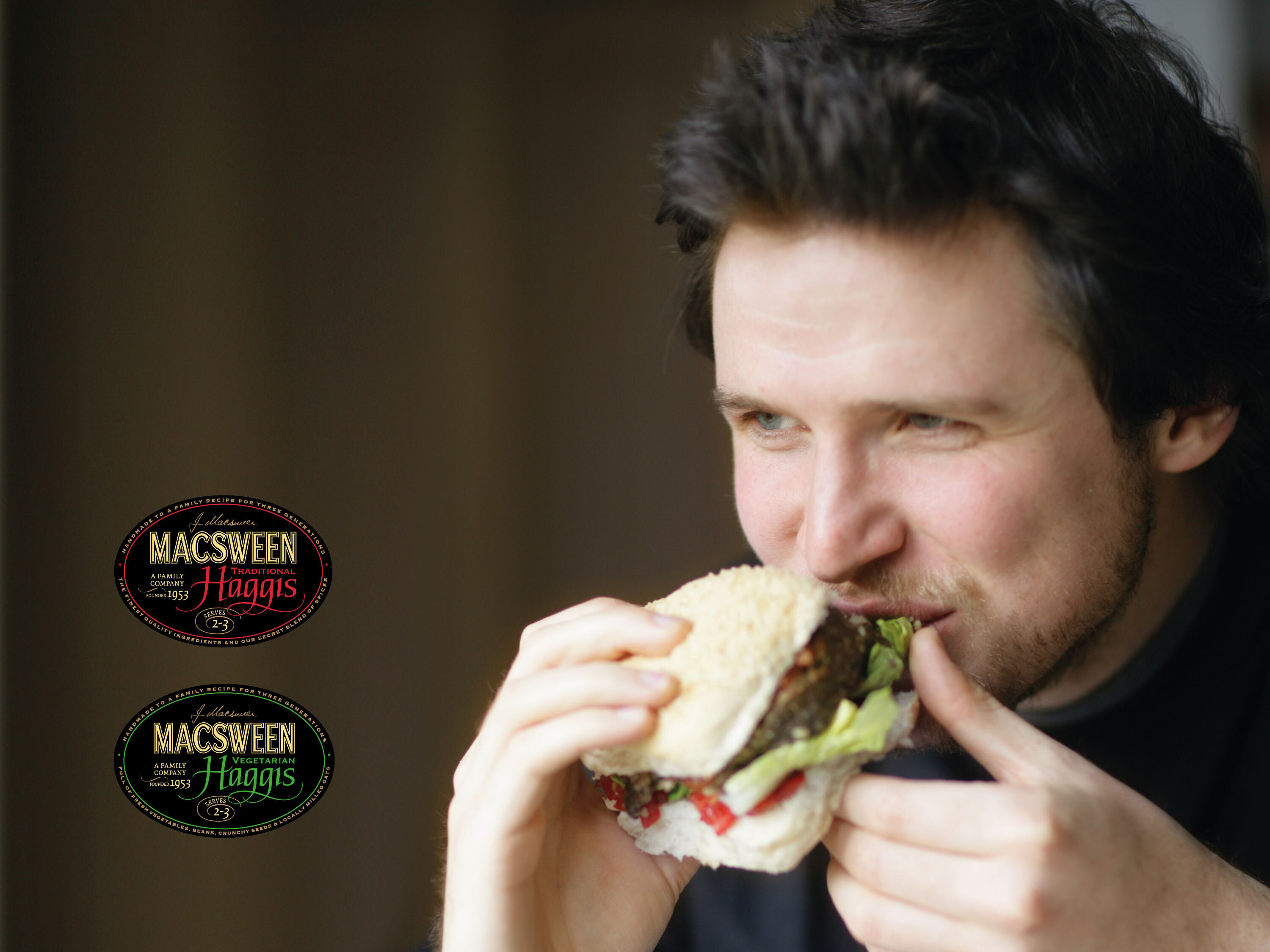 Man eating haggis and salad roll. Macsween meat and vegetarian labels also shown.